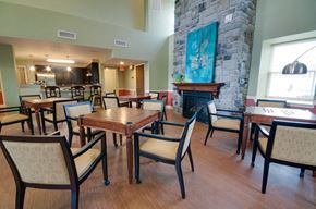 Elkton apartment for rent - a dining room with tables and chairs and a stone fireplace