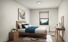 New Brunswick apartment for rent - A bedroom with a bed, nightstand, and a window with a view of trees.