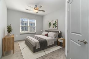 Myrtle Beach apartment for rent - A bedroom with a bed, nightstand, and window at The Parker Myrtle Beach, Myrtle Beach, SC