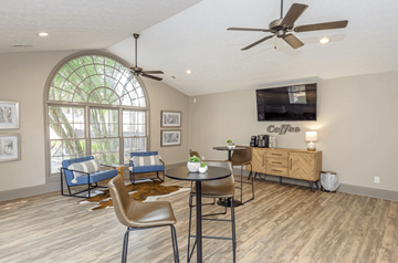 Marietta apartment for rent - A living room with a round table and chairs, a sofa, and a television.