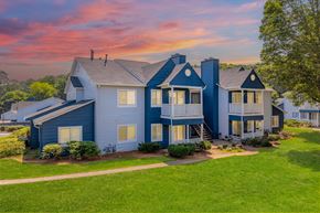 Stone Mountain apartment for rent - A large blue house with a white roof and a tree in front.