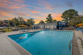 Stone Mountain apartment for rent - A large swimming pool with a building in the background during sunset.