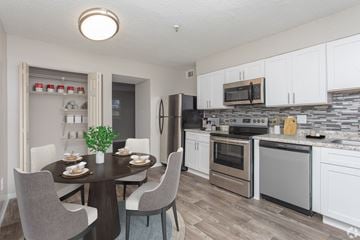 Avondale Estates apartment for rent - A modern kitchen with a dining table set for two.