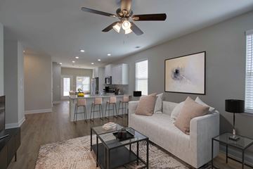 Augusta apartment for rent - A living room with a white couch and a ceiling fan.
