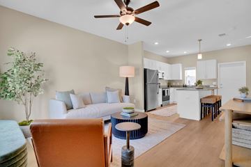 Winter Haven apartment for rent - A living room with a brown chair and a ceiling fan.