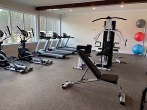 Bloomingdale apartment for rent - A gym with treadmills, elliptical machines, and weights.