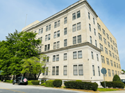 Columbia apartment for rent - A large, two-story building with a flat roof and a mix of windows and shutters.
