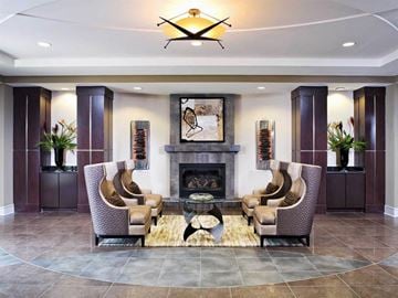 Gaithersburg apartment for rent - a large living room with a fireplace and chairs