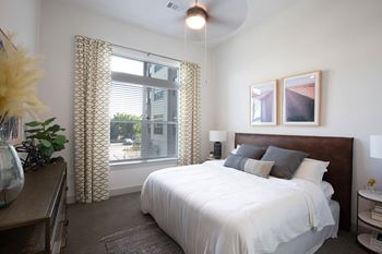 A bedroom with a large bed and a window