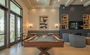 Kennesaw apartment for rent - A pool table is in the middle of a room with a fireplace and a TV at The Ashton at East Park Apartments, Georgia, 30144