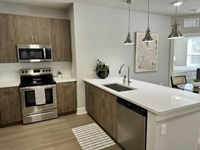 Atlanta apartment for rent - A modern kitchen with a stainless steel oven and a white countertop at The Collective Upper Westside Apartments, Atlanta, GA, 30318