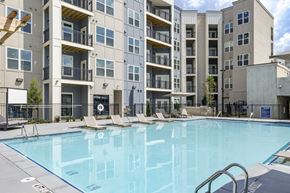 Atlanta apartment for rent - A swimming pool in front of a multi-story apartment building at The Collective Upper Westside Apartments, Atlanta, GA, 30318