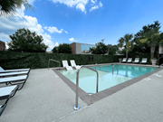 Columbia apartment for rent - A pool surrounded by a concrete floor and a hedge.