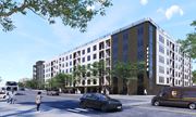 Atlanta apartment for rent - A street view with a building, cars, and a person.