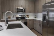 Winter Haven apartment for rent - A modern kitchen with a stainless steel refrigerator and a white countertop at The Waverly at Winter Haven Apartments, Florida, 33884