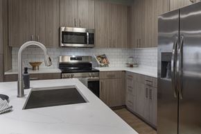 Winter Haven apartment for rent - A modern kitchen with a stainless steel refrigerator and a white countertop at The Waverly at Winter Haven Apartments, Florida, 33884