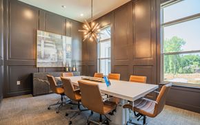 Kennesaw apartment for rent - A conference room with a long table and chairs at The Ashton at East Park Apartments, Kennesaw, GA