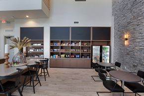 Austin apartment for rent - a dining room with tables and chairs and a bar with shelves at The Monroe Apartments, Texas, 78741