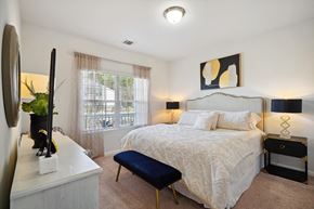 Bloomingdale apartment for rent - Bedroom with a bed and a dresser and a window  at The Meadows, Bloomingdale, GA, 31302