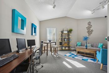 Spacious living room and dining room with a table and chairs and a computer desk