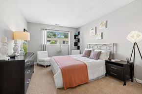 Charleston apartment for rent - A bedroom with a bed, nightstand, and chair.