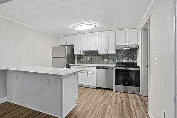 Woodstock apartment for rent - A kitchen with white cabinets and stainless steel appliances.