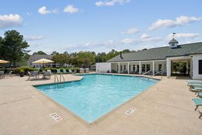 Aiken apartment for rent - A large swimming pool with a building in the background.