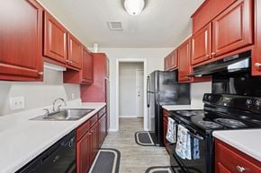 Raleigh apartment for rent - Kitchen with Red Cabinets at Casa de Luna Apartments, Raleigh, NC