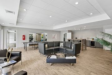 Marietta apartment for rent - A living room with a grey sofa and a black chair.