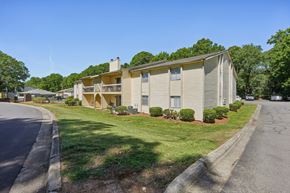 Charlotte apartment for rent - A residential building with a green lawn in front.