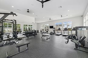 Crestview apartment for rent - A spacious gym with a variety of equipment and a ceiling fan.at The Exchange at Crestview Apartments, Crestview, 32536