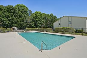 Charlotte apartment for rent - A small pool surrounded by a fence and trees.
