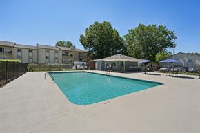 Charlotte apartment for rent - A swimming pool in a sunny day surrounded by apartment buildings.