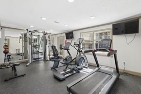 Durham townhouse for rent - A spacious gym with treadmills, weights, and exercise equipment.