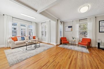 Raleigh apartment for rent - A living room with a white couch and a coffee table.