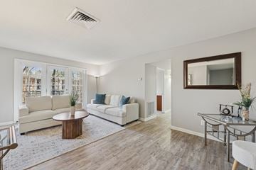 Raleigh apartment for rent - A living room with a white couch and a coffee table.