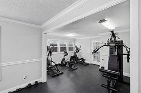 Antioch apartment for rent - A black and white photo of a home gym with a treadmill, stationary bike, and other equipment.