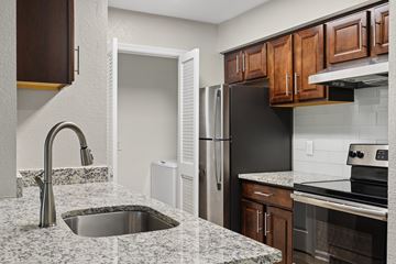 Hendersonville apartment for rent - A kitchen with a sink and a refrigerator.