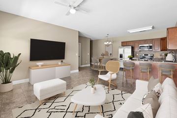 Paducah apartment for rent - A living room with a white couch and a black television.