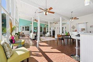 Charleston apartment for rent - A sunny day in a spacious living room with a yellow sofa and a dining table.
