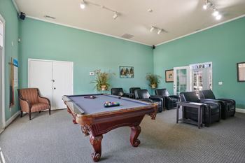 Game room with a pool table and leather furniture