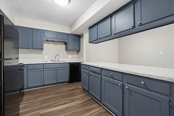 Charlotte apartment for rent - A kitchen with dark blue cabinets and a white countertop.