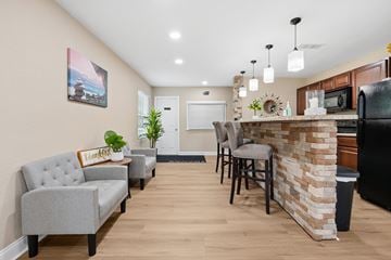 Charlotte apartment for rent - A kitchen with a bar area and a grey couch.
