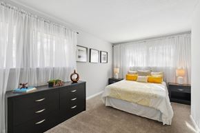 Durham townhouse for rent - A bedroom with a bed, nightstands, and pictures on the wall.