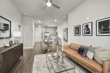 Nashville apartment for rent - A living room with a brown couch and a glass coffee table.