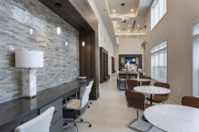 Winter Haven apartment for rent - A modern dining area with a stone wall and a television at The Waverly at Winter Haven Apartments, Winter Haven, Florida