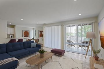Landover Hills apartment for rent - A blue sofa sits in a living room with a wooden coffee table in front of it.