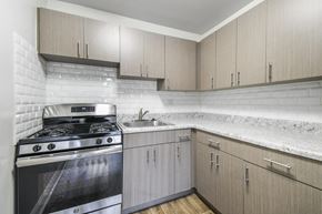 Silver Spring apartment for rent - A modern kitchen with a stove and cabinets.