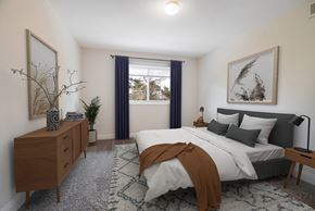 Silver Spring apartment for rent - A bedroom with a large bed and a wooden dresser.