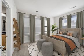 Washington apartment for rent - A bedroom with a large bed and a wooden ladder.